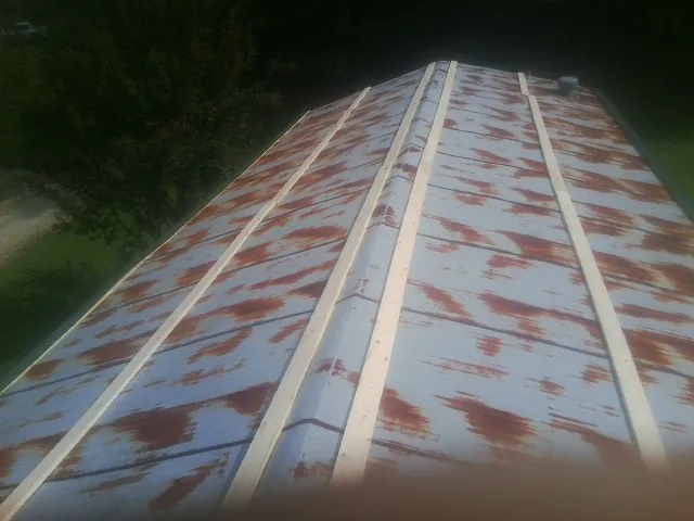 Rusted metal roof panels with new wood purlins before replacement — Storm Damage Roof Repair in Warners by Roofing Brothers